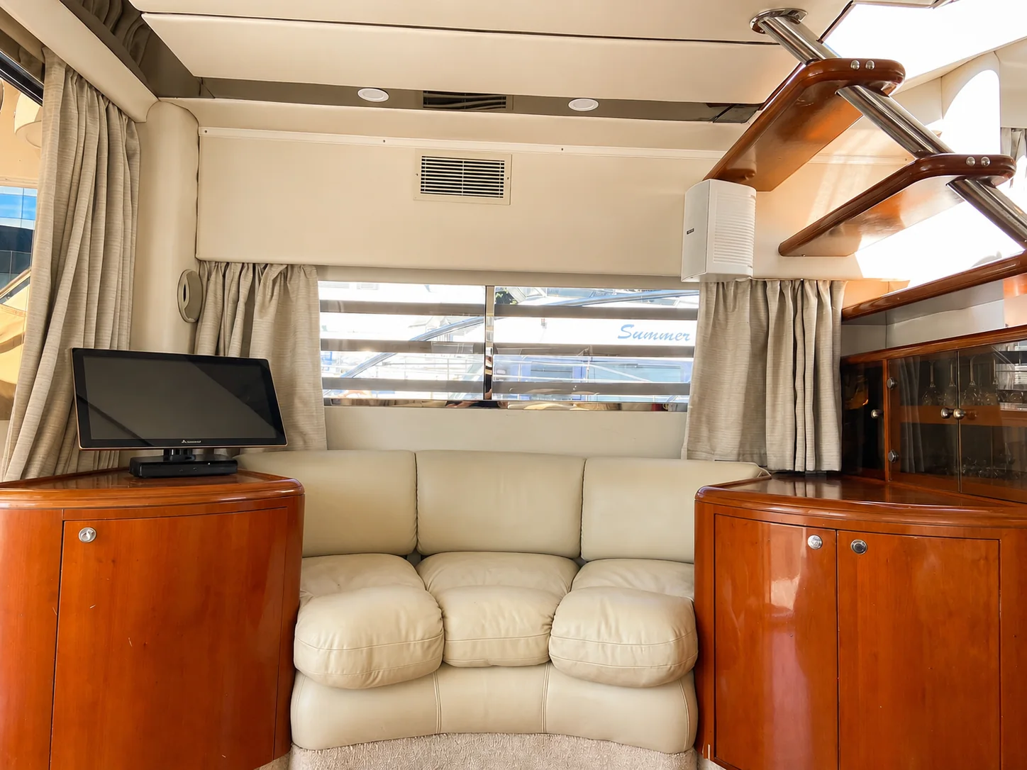 Salon seating and polished cabinetry aboard the Fairline Celeste yacht