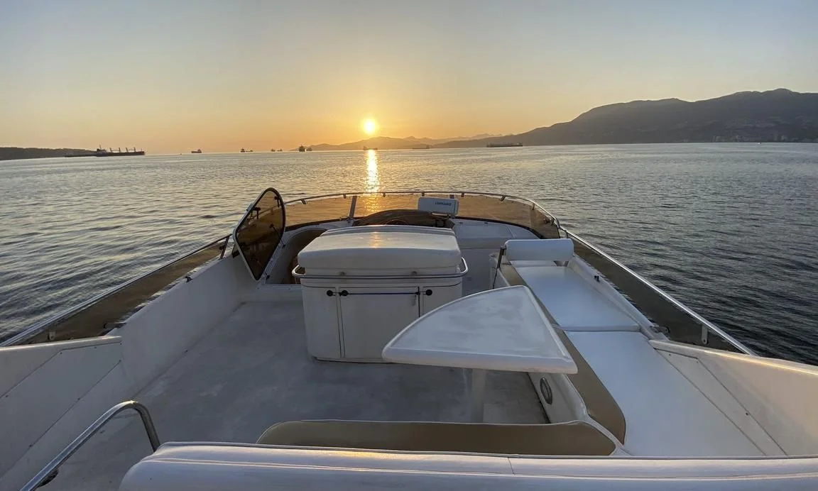 Open flybridge seating aboard the Fairline Celeste yacht at sunset