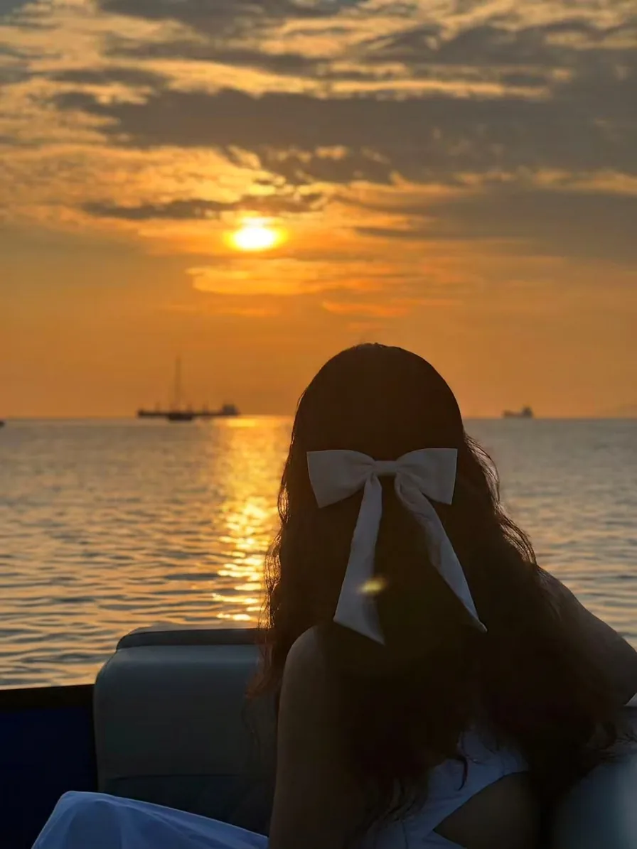 Romantic sunset cruise Vancouver — couple silhouette at golden hour over English Bay, SeaSky Cruises