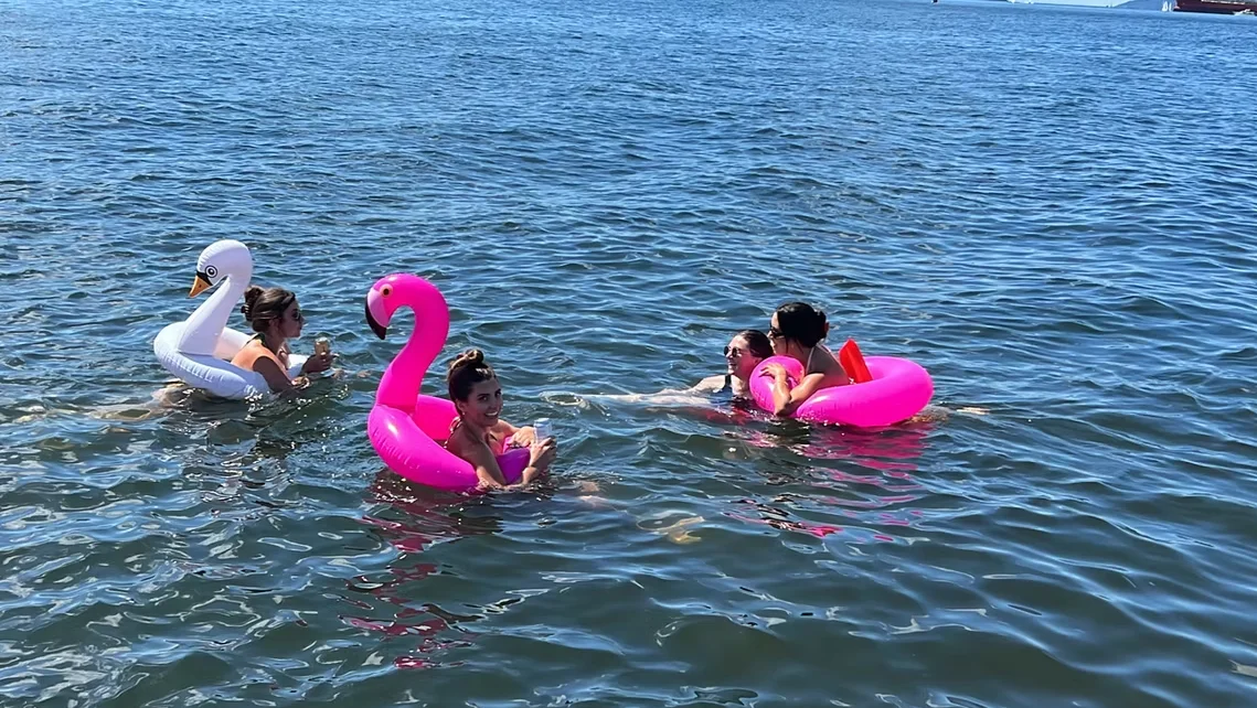 Swimming and floaties during a private pontoon boat swim stop near Indian Arm and Deep Cove with SeaSky Cruises