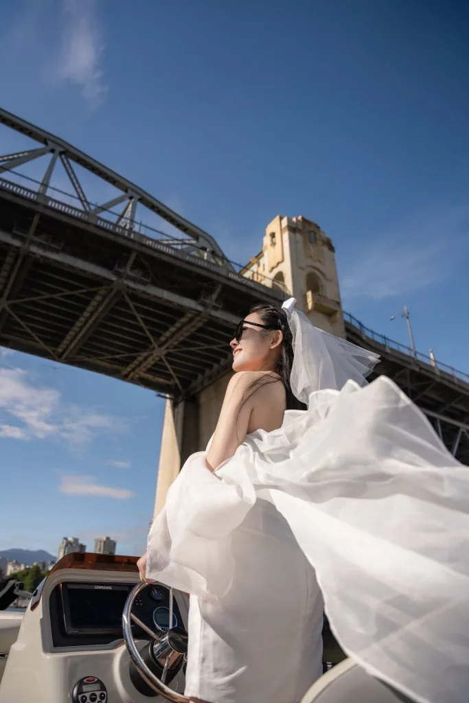 Proposal style pontoon cruise with wedding dress near Burrard Bridge in Vancouver by SeaSky Cruises